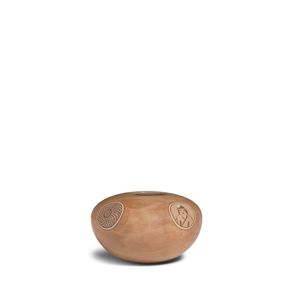 A Dextra Quotskuyva Nampeyo sgraffito jar: Dextra Quotskuyva Nampeyo Hopi-Tewa, (1928-2019), a sgraffito seed jar, polished buffware with four rondels alternating between a serrated spiral whorl design, a Puebloan cliff dwelling, and a
