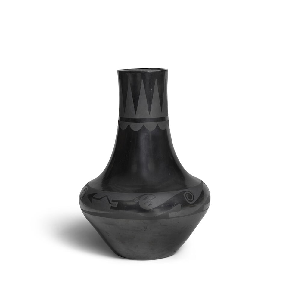 A Maria Martinez blackware vase: Maria Martinez San Ildefonso, (1887-1980), a blackware vase, the lengthy neck painted with serrates and cloud motifs, an attenuated avanyu at the shoulder, the six humps terminating as spirals,