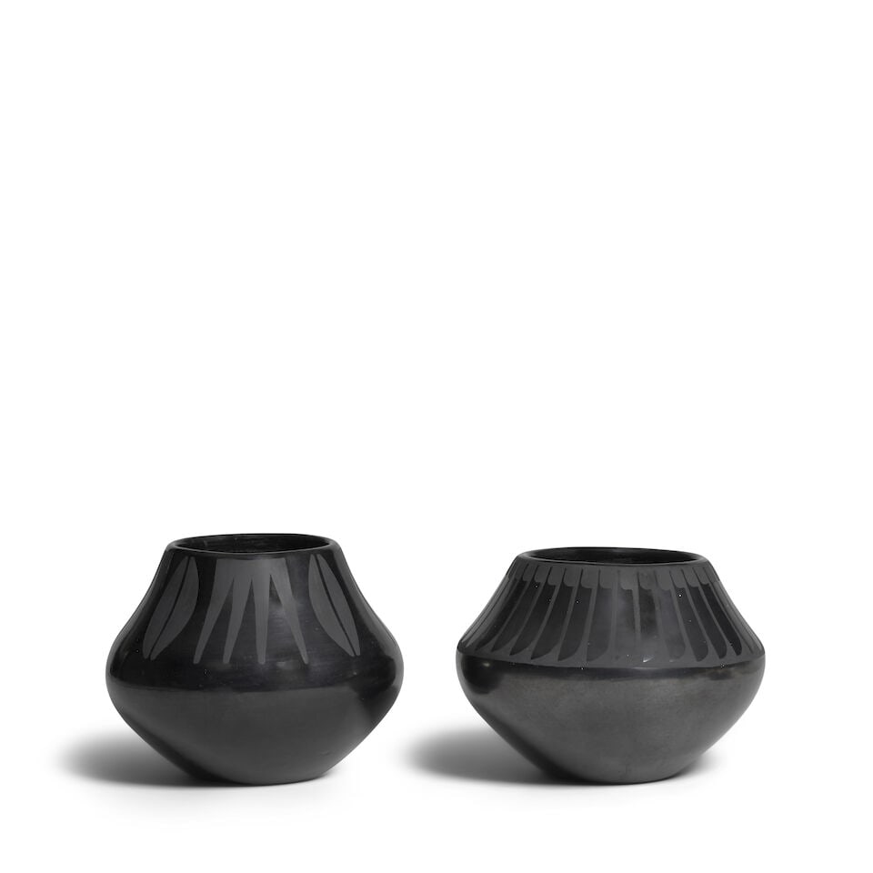 Two Maria Martinez blackware jars: Maria Martinez San Ildefonso, (1887-1980), two blackware jars, one painted with serrates and split ovoids by husband Julian Martinez, (1879-1943), signed 'Marie + Julian'; the other in a repeat