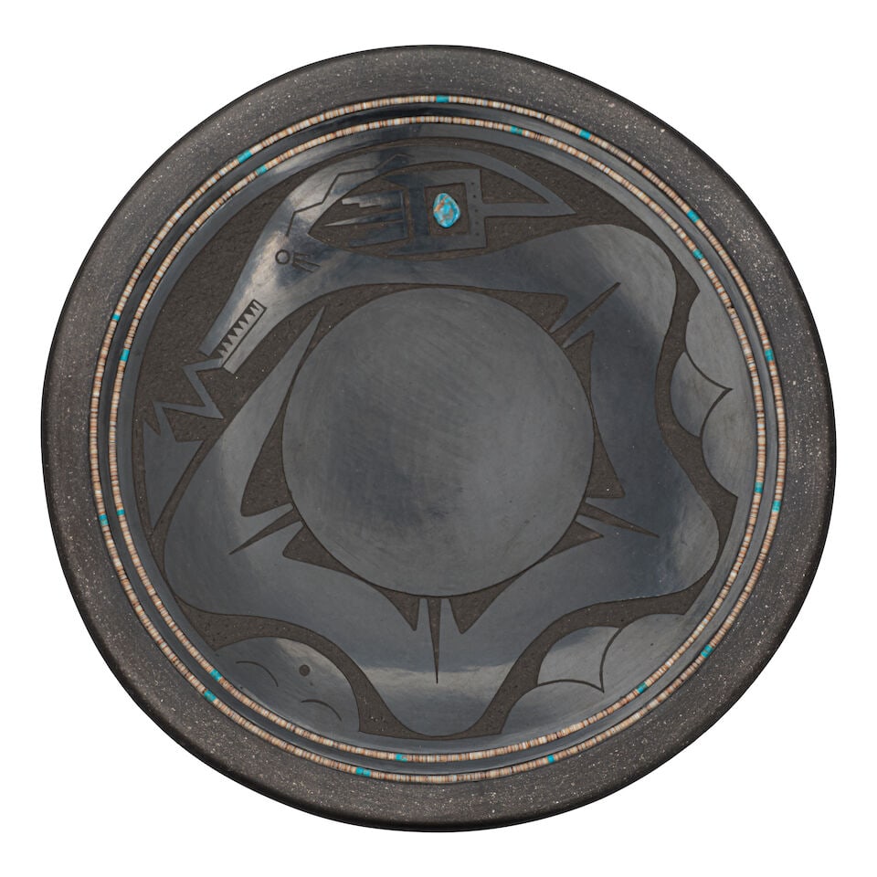A Russell Sanchez sgraffito blackware plate: Russell Sanchez San Ildefonso, (b. 1963), a blackware plate, a sgraffito 4-humped avanyu encircling the center, a gem-polished turquoise set in the horn, a double band of heishi and turquoise beads
