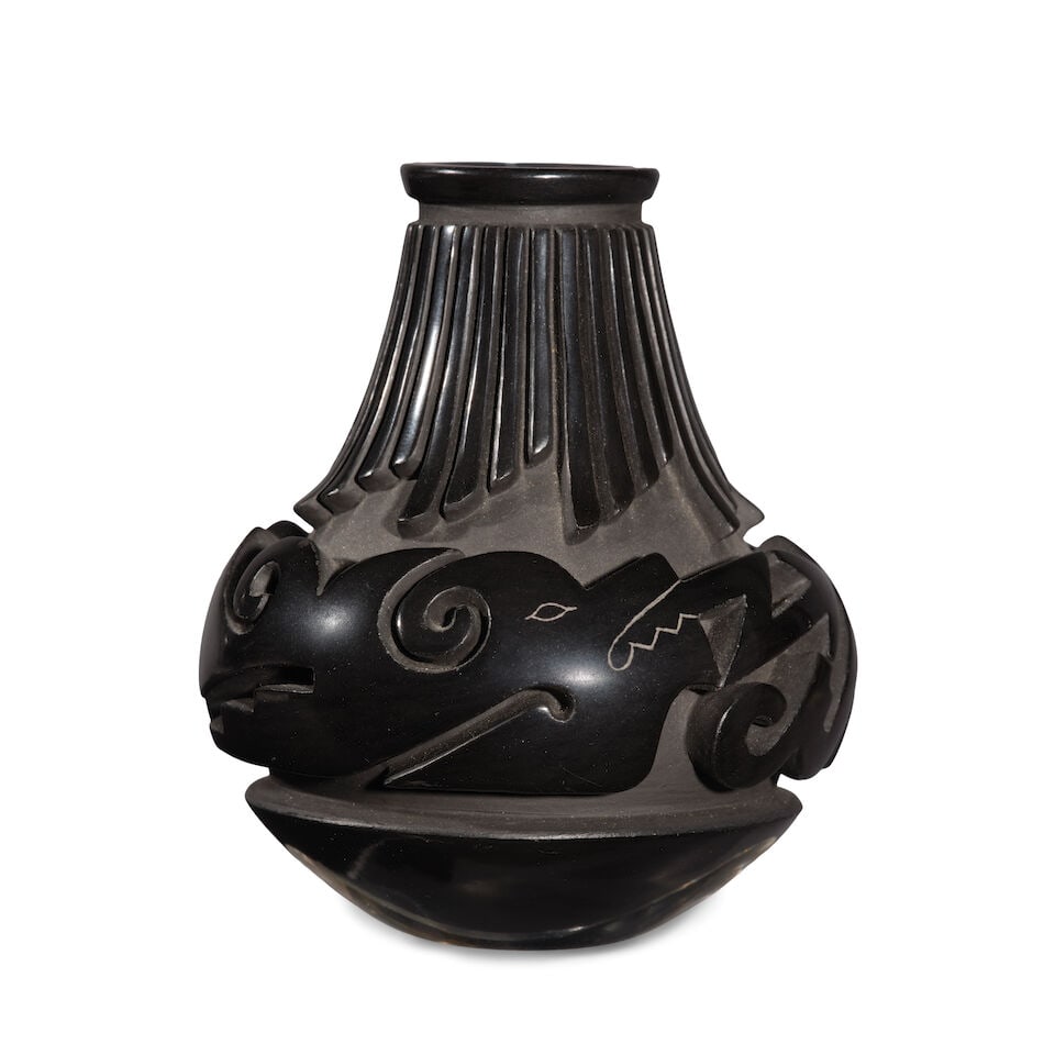 A Nancy Youngblood carved blackware miniature vase: Nancy Youngblood Santa Clara, (b. 1955), 1988, a carved blackware miniature vase, staggered feather patterns down the neck, an avanyu about the center, dated and signed 'Nancy Youngblood Cutler' at