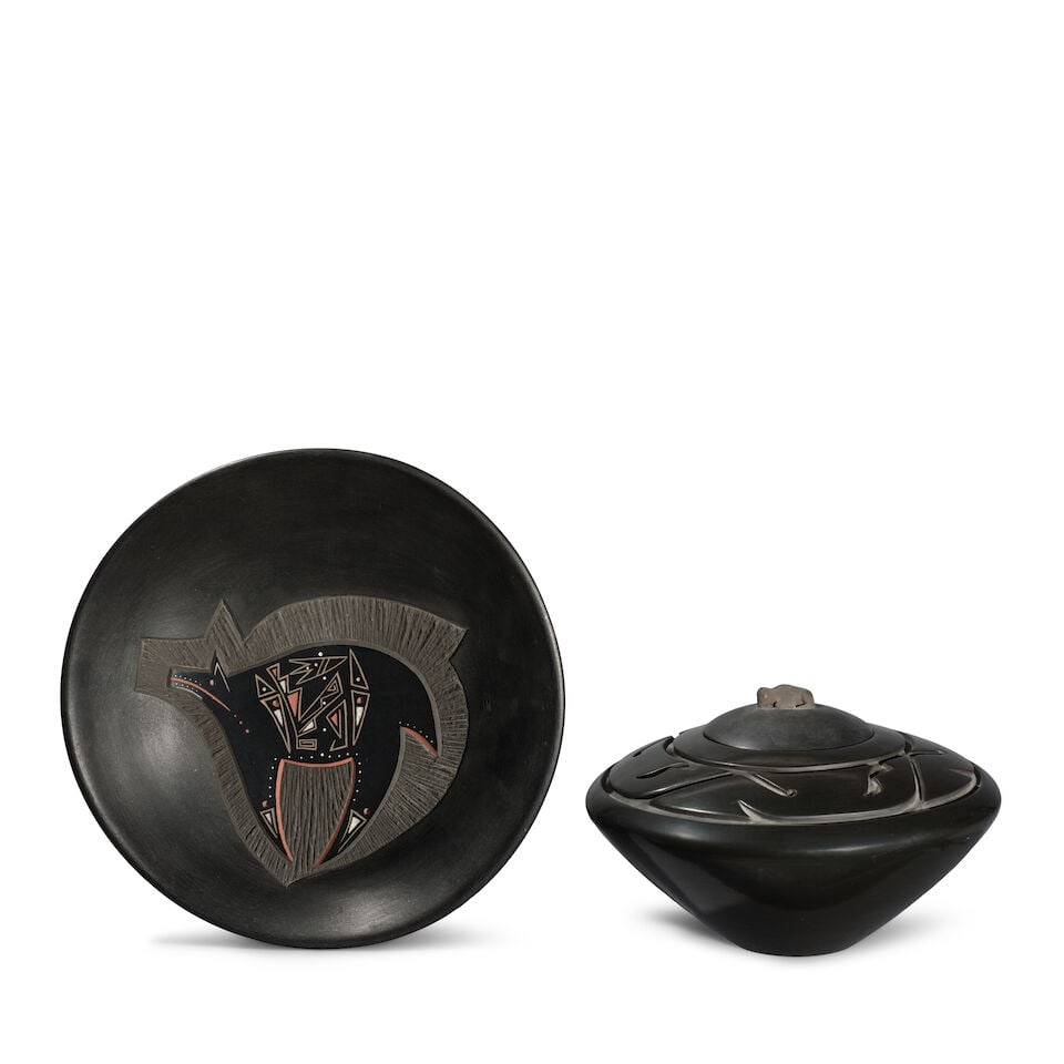 Two Santa Clara Pueblo blackware pottery items: Two Santa Clara Pueblo blackware pottery items Including a sgraffito plate with depiction of a bear, Art Cody Haungooah (1943-1985), signed 'Haungooah' inside a leaping fish; and a carved lidded jar w