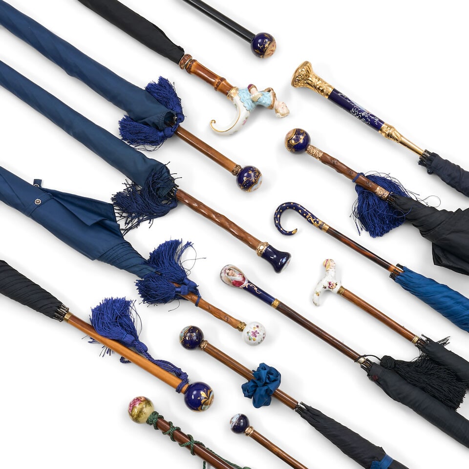 Fourteen Porcelain-mounted Umbrellas, 20th century,: Fourteen Porcelain-mounted Umbrellas, 20th century, including five with porcelain knob handles decorated with putti reserves on a cobalt blue ground, lg. 39 1/2 in. For further information on this