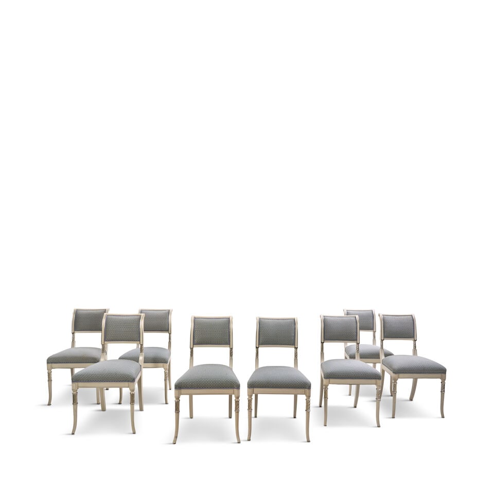 Suite of Eight Modern Regency-style Cream-painted and Silvered Dining Chairs,: Suite of Eight Modern Regency-style Cream-painted and Silvered Dining Chairs, each with an upholstered rectangular back and padded seat, raised on molded saber legs, ht. 36 1/2, wd. 15 1/2, dp. 20,