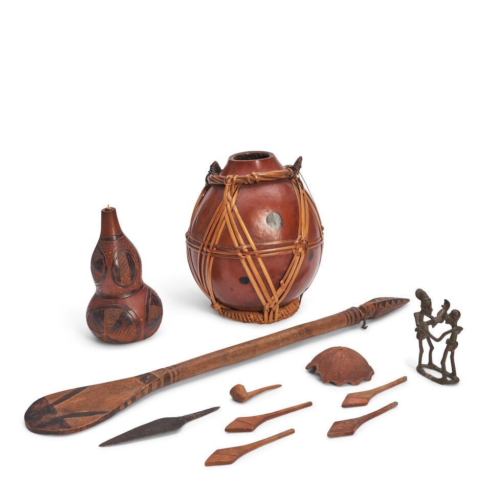 A Group Of African Collectible Items,: A Group Of African Collectible Items, Comprising two gourd vessels, a carved wood ceremonial paddle, lg. 26 in., a small cast metal group of figures, a metal spearhead, and assorted carved wooden obje