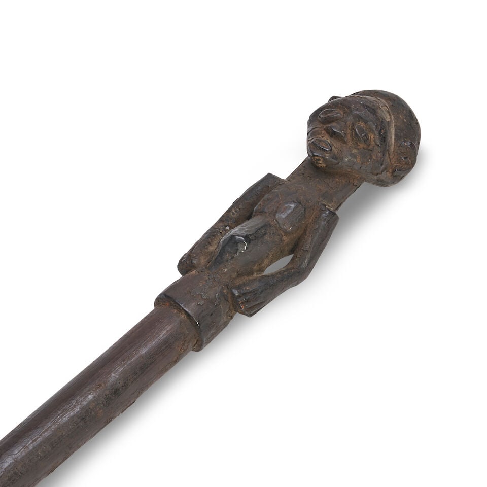 Congo Carved Wood Staff With Figural Finial,: Congo Carved Wood Staff With Figural Finial, Carved with a standing figure at the top, above a long tapering shaft with raised nodes, terminating in an iron spike, lg. 46 in. Lot to be sold without re