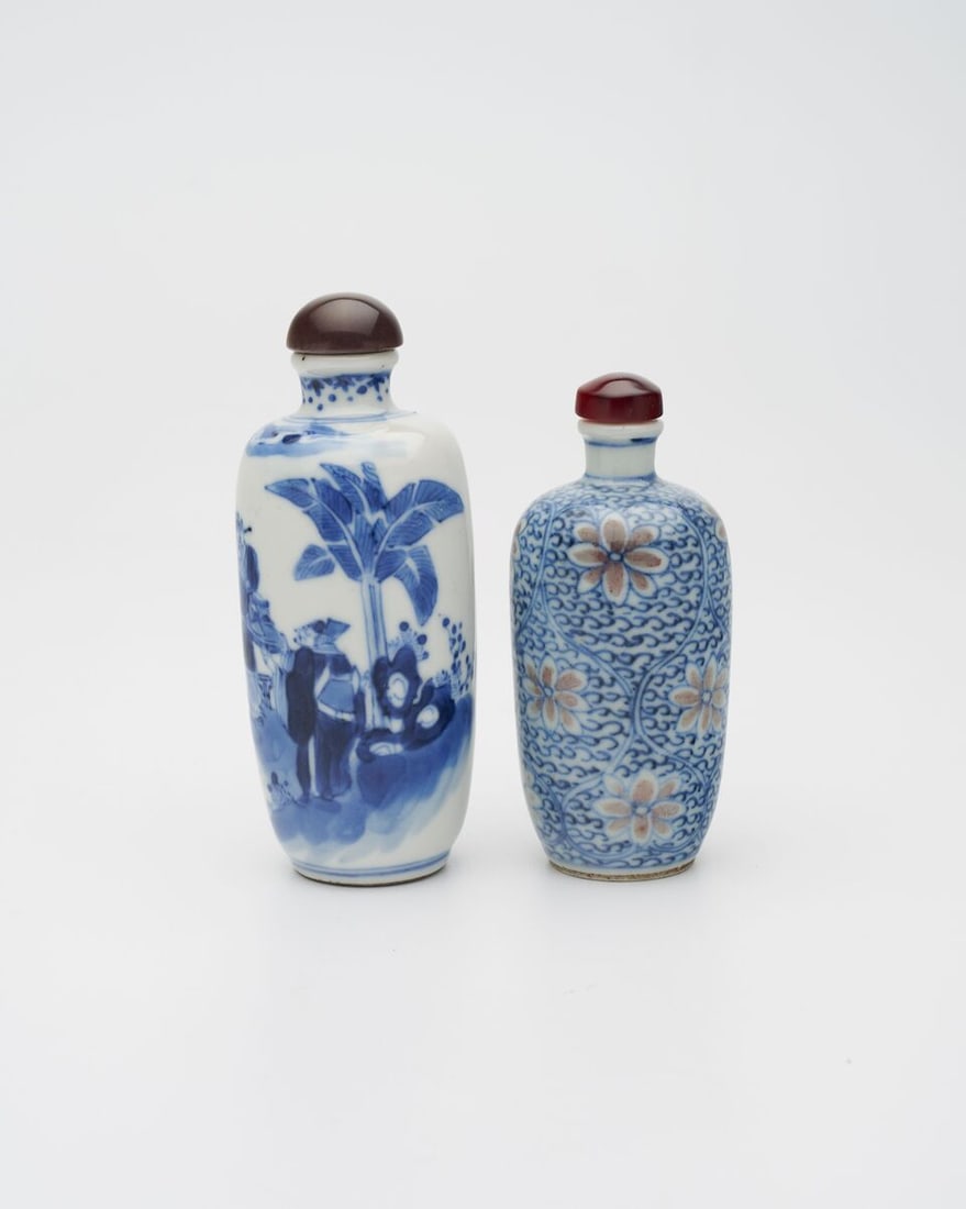 AN UNDERGLAZE-BLUE AND COPPER-RED 'LOTUS', AND A BLUE AND WHITE 'FIGURES' SNUFF BOTTLE Late Qing... (1 of 17)