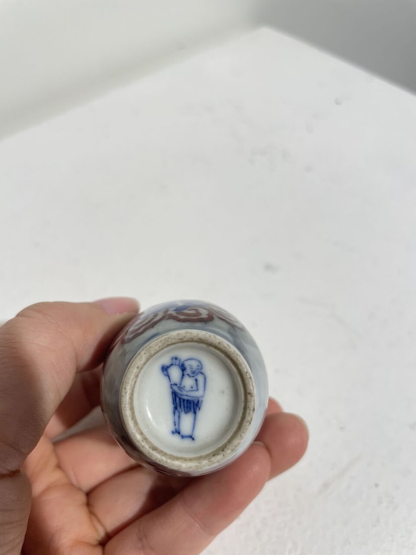AN UNDERGLAZE-BLUE AND COPPER-RED 'FIGURES AMONG CLOUDS' SNUFF BOTTLE Underglaze-blue pictorial ... - 2