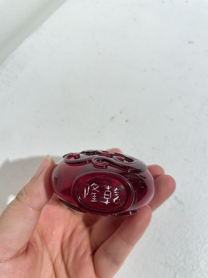 A RUBY-RED GLASS 'DRAGON AND PHOENIX' SNUFF BOTTLE Qianlong two-character wheel-cut mark, 19th c... - 2