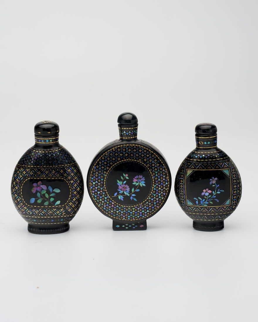 THREE LAC BURGAUTE SNUFF BOTTLES One of Qianli mark, 19th century (3): THREE LAC BURGAUTE SNUFF BOTTLES One of Qianli mark, 19th century Measured without the stoppers varying sizes from 6.1cm to 6.7cm high (3). Footnotes: Provenance: (the flattened ovoid one) Sotheby's,
