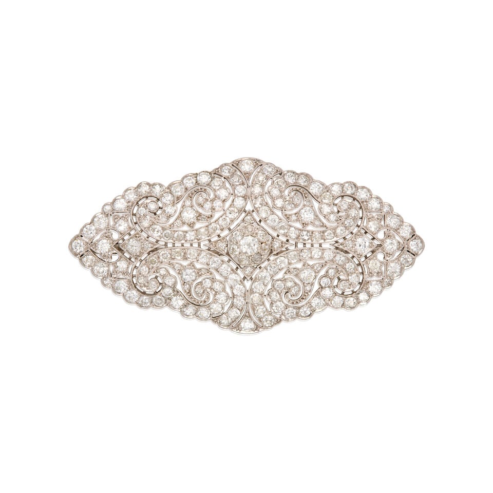A PLATINUM AND DIAMOND BROOCH: A PLATINUM AND DIAMOND BROOCH • Numerous round shaped diamonds weighing approximately 1.80 carats total • Measures 2 13/16 in. x 1 7/16 in. • Estimated gross weight: 18.6