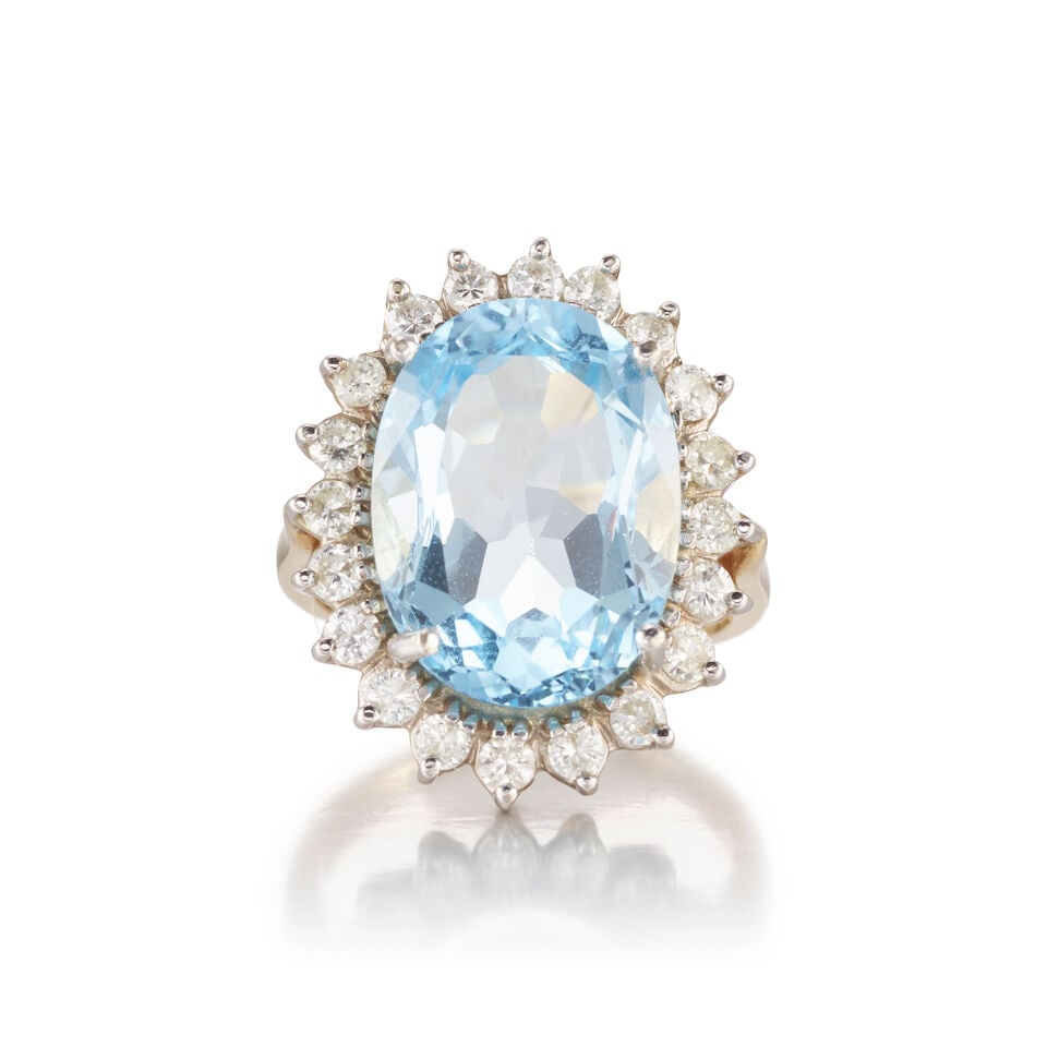 13K YELLOW GOLD, TOPAZ, AND DIAMOND RING: 13K YELLOW GOLD, TOPAZ, AND DIAMOND RING • An oval shaped topaz weighing approximately 9.50 carats • Numerous round shaped diamonds weighing approximately 0.40 carat total • Size 6