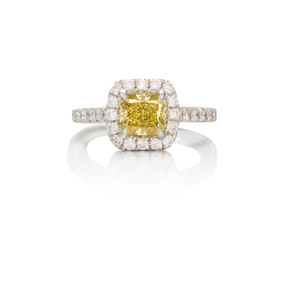 PLATINUM, COLORED DIAMOND, AND DIAMOND RING: PLATINUM, COLORED DIAMOND, AND DIAMOND RING • A square shaped diamond weighing approximately 0.80 carat • Numerous round brilliant cut diamonds weighing approximately 0.25 carat total R
