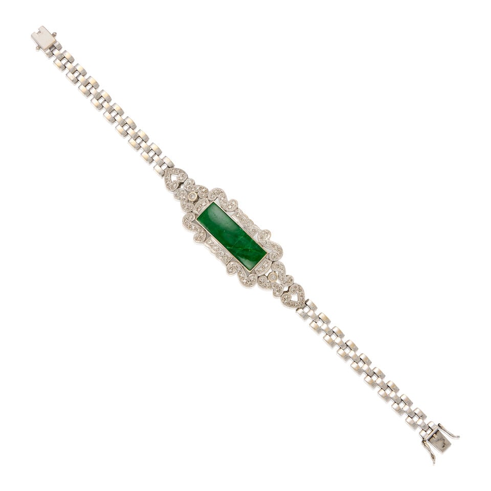 18K WHITE GOLD, JADE AND DIAMOND BRACELET: 18K WHITE GOLD, JADE AND DIAMOND BRACELET • One rectangular jade measuring approximately 24.24mm x 8.18mm x depth cannot be determined due to the setting • Numerous round single cut