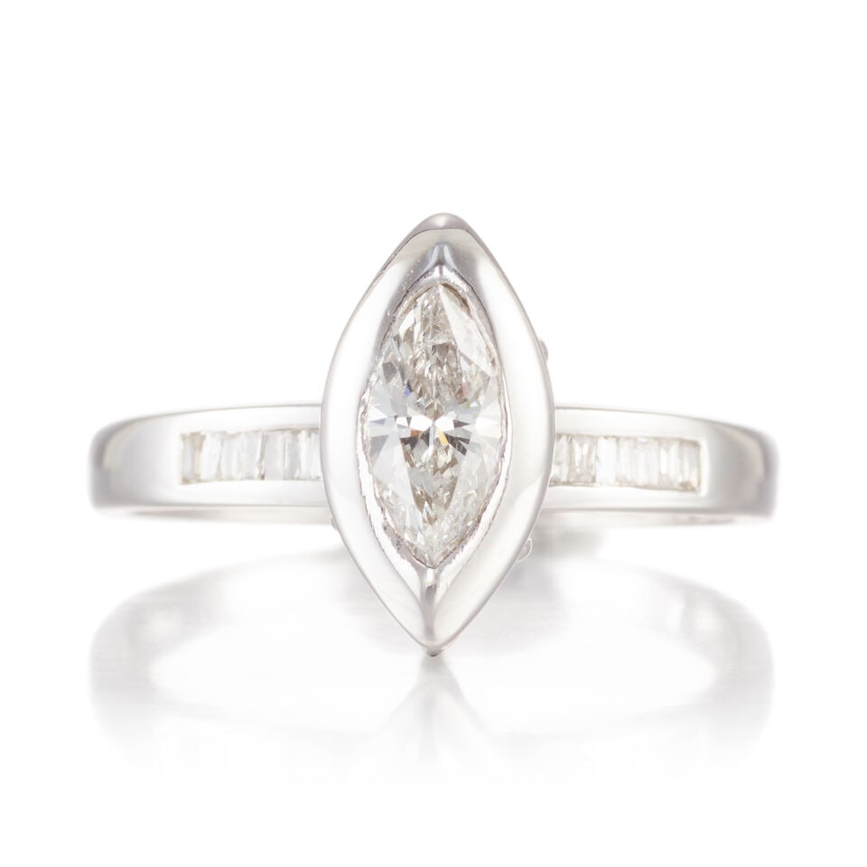 14K WHITE GOLD AND DIAMOND RING: 14K WHITE GOLD AND DIAMOND RING • One marquise shaped diamond weighing approximately 0.50 carat • Numerous rectangular shaped diamonds weighing approximately 0.25 carat total • Size
