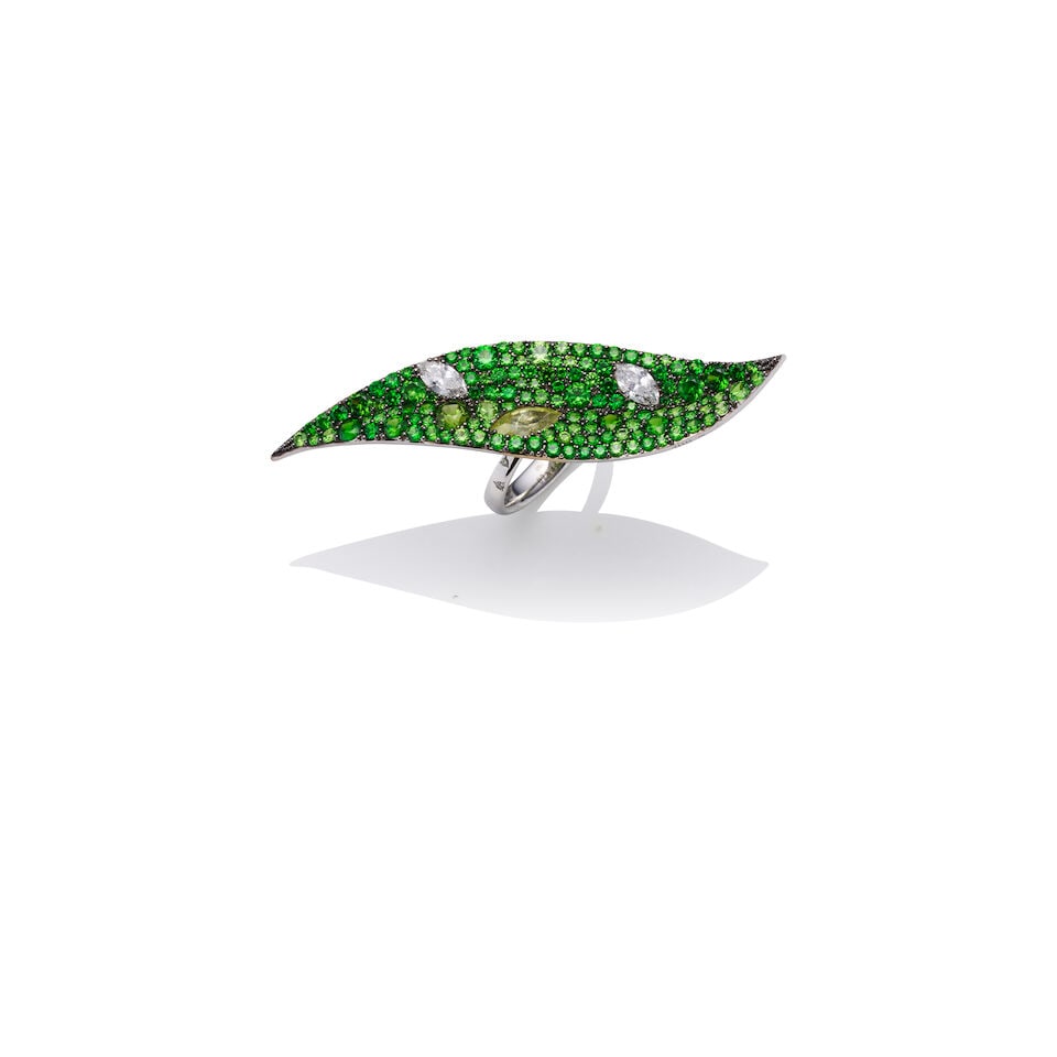 TENZO | GARNET AND DIAMOND RING: TENZO | GARNET AND DIAMOND RING - Elongated leaf motif ring, pavé set throughout with round green garnets of various sizes - Accented with 2 marquise-cut diamond and 1 yellowish-green garnet - 6
