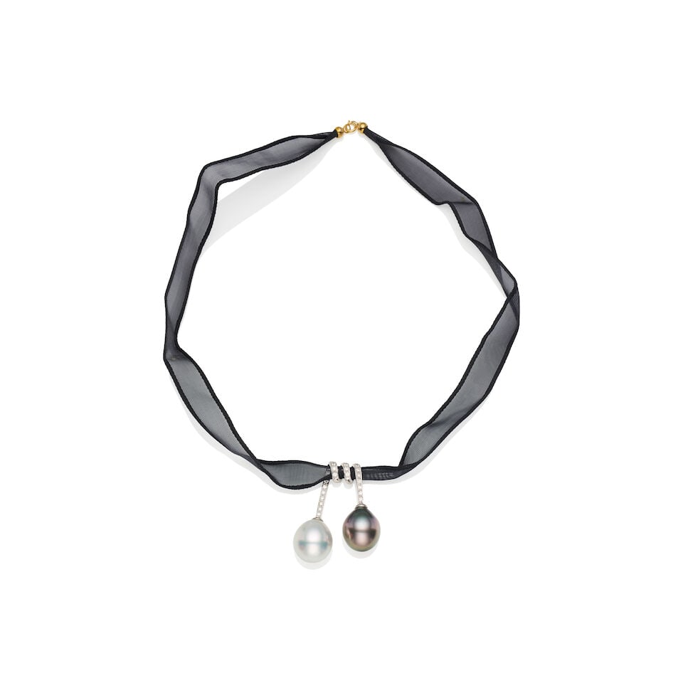 WHITE AND TAHITIAN CULTURED PEARL AND DIAMOND PENDANT: WHITE AND TAHITIAN CULTURED PEARL AND DIAMOND PENDANT - Twin-drop pearl pendant threaded onto a sheer organza black ribbon, full length approximately 40cm. - One 14mm white South Sea drop shape