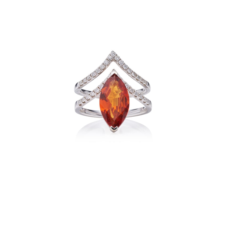 ORANGE GARNET AND DIAMOND RING: ORANGE GARNET AND DIAMOND RING - Claw set marquise-cut orange garnet, weighing approximately 3.7ct. - Double rows of brilliant-cut diamonds - Stamped 750, D0.43 - Weight: 7.10gm - Ring size: