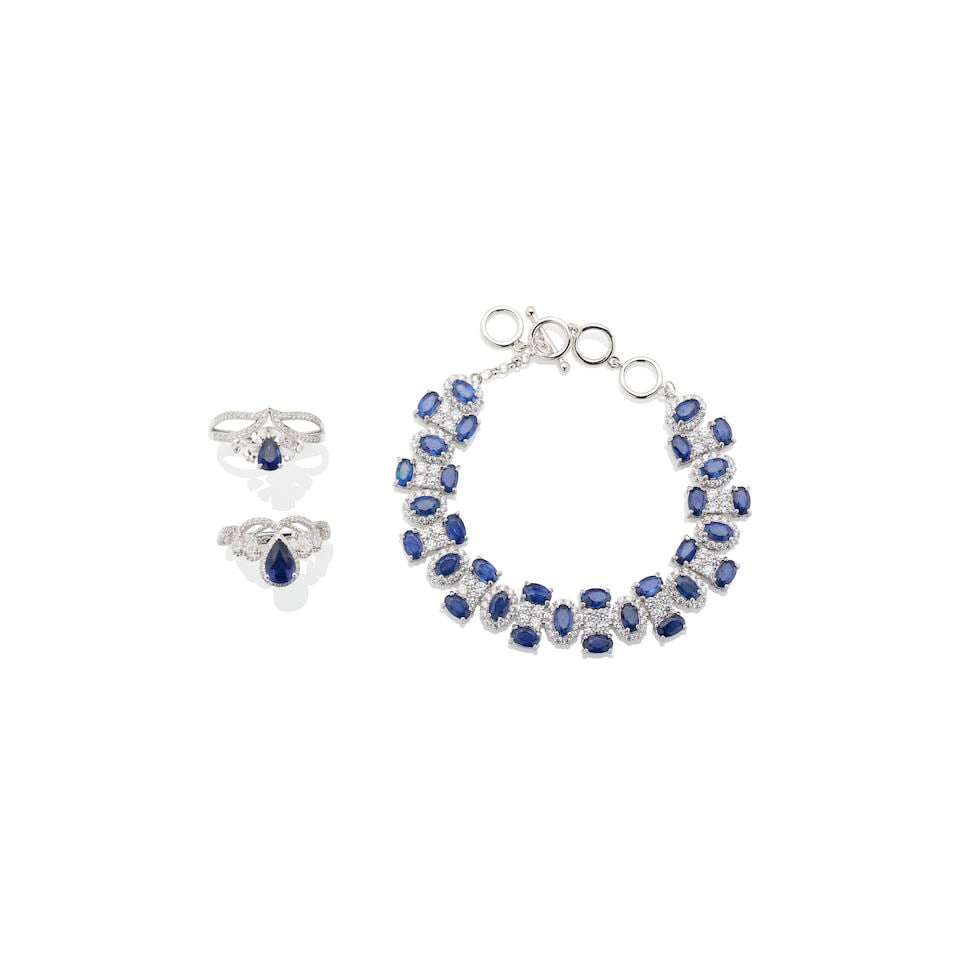 GROUP OF SAPPHIRE JEWELLERY: GROUP OF SAPPHIRE JEWELLERY 1. Sapphire ring - Centre pear-cut sapphire weighing approximately 0.70ct - Pear-cut white sapphires and round-cut white accent crystals on the shoulders - Stamped G18K;