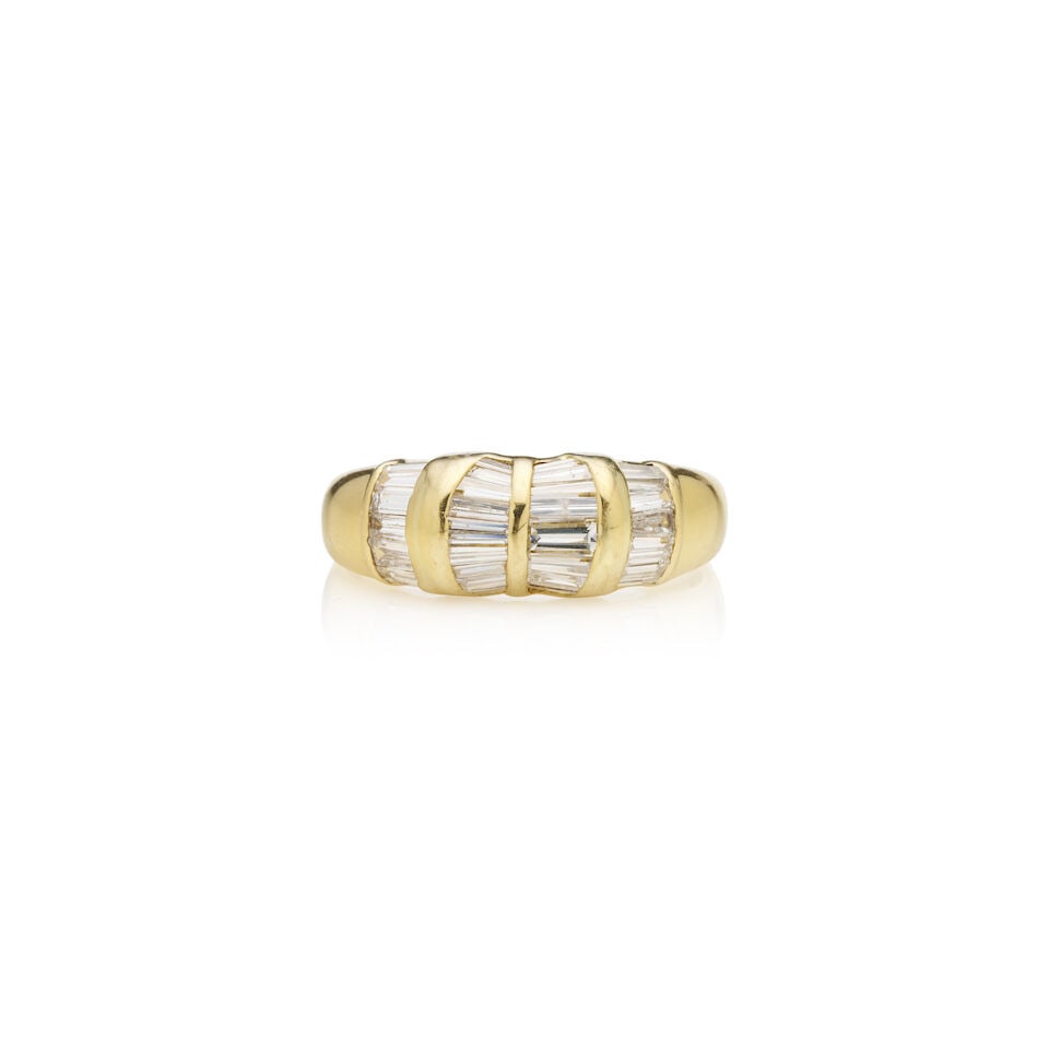 DIAMOND RING: DIAMOND RING - Set in four sections with 27 baguette and tapered baguette diamonds - Stamped 750 - weight 5.0gm, ring size O 1/2. Footnotes: OVERALL CONDITION: Metal stamped 750 for 18ct gold;