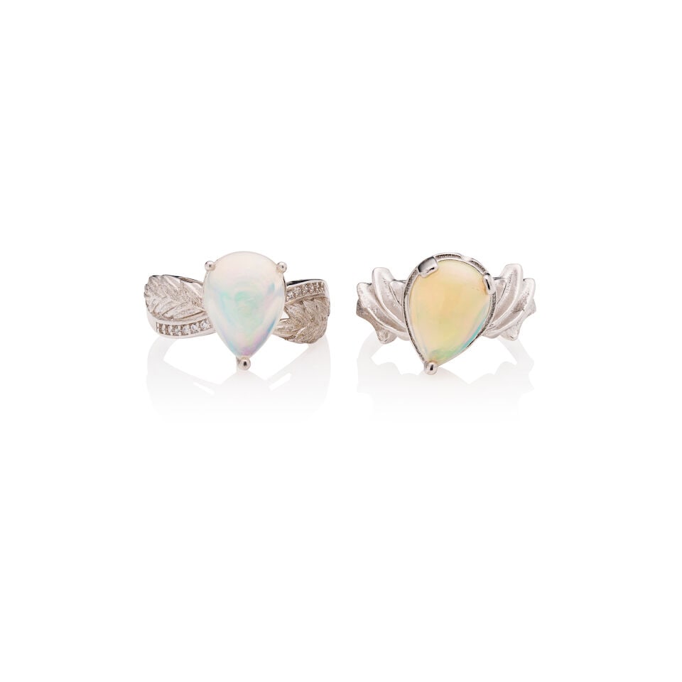 TWO OPAL RINGS: TWO OPAL RINGS 1. Opal ring - Pear-shaped cabochon opal measuring approximately 12.3 x 8.0 x 4.8mm - Round white accent crystals - Stamped S925; Estimated gross weight approximately: 3.6gm; size P