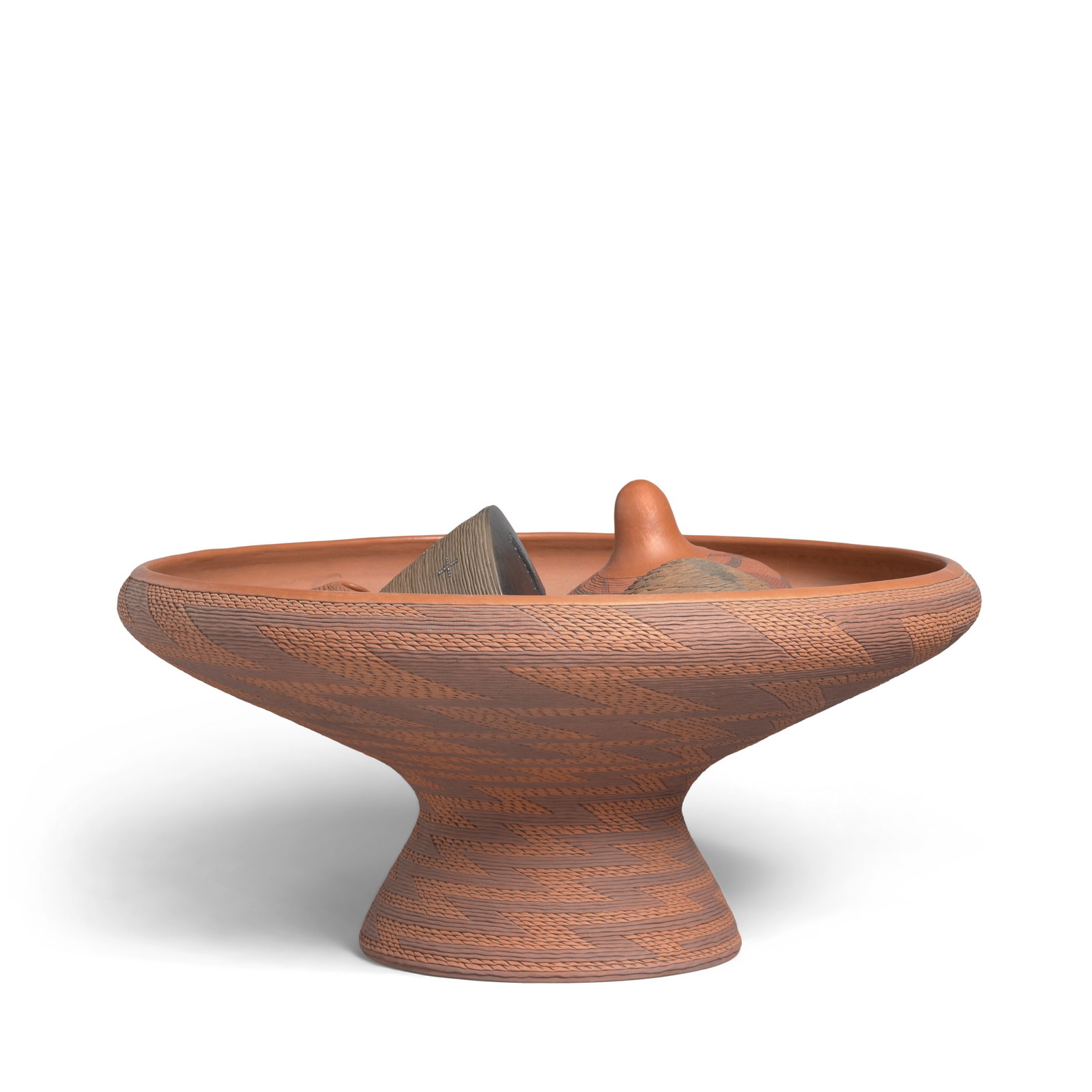A Richard Zane Smith pottery garden, 1995: Richard Zane Smith Wyandot, (b.1955), a pottery garden, comprising a large polychrome corrugated pedestal vessel containing five ancillary vessels and pottery shards in a bed of sand, the principal co