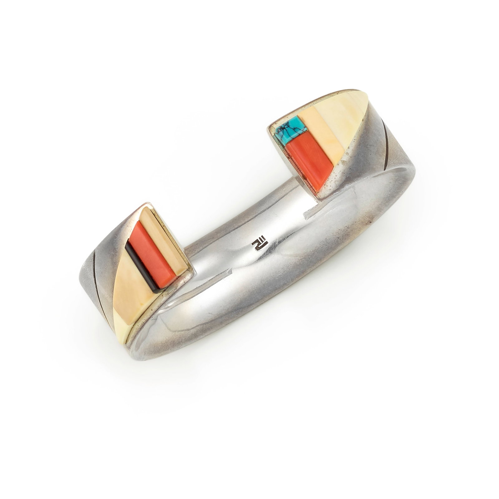 A Richard Chavez silver and multi-stone cuff bracelet: Richard Chavez San Felipe, (b. 1949), a silver cuff bracelet with rounded interior, the outer surface with brushed finish, the polished ends set with a mosaic of coral, turquoise, black jade and other