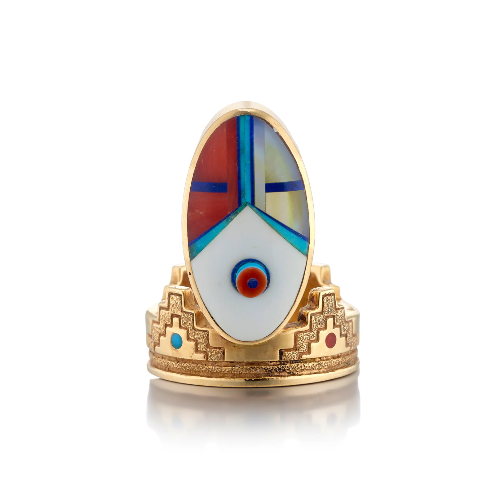 A Jesse Monongya 14k gold and multi-stone katsina face ring: Jesse Monongya Diné (Navajo)/Hopi, (1952-2024), a ring in 14k gold, with raised katsina face above a crenelated band, set with a mosaic of turquoise, lapis and coral, stamped with maker's mark: J