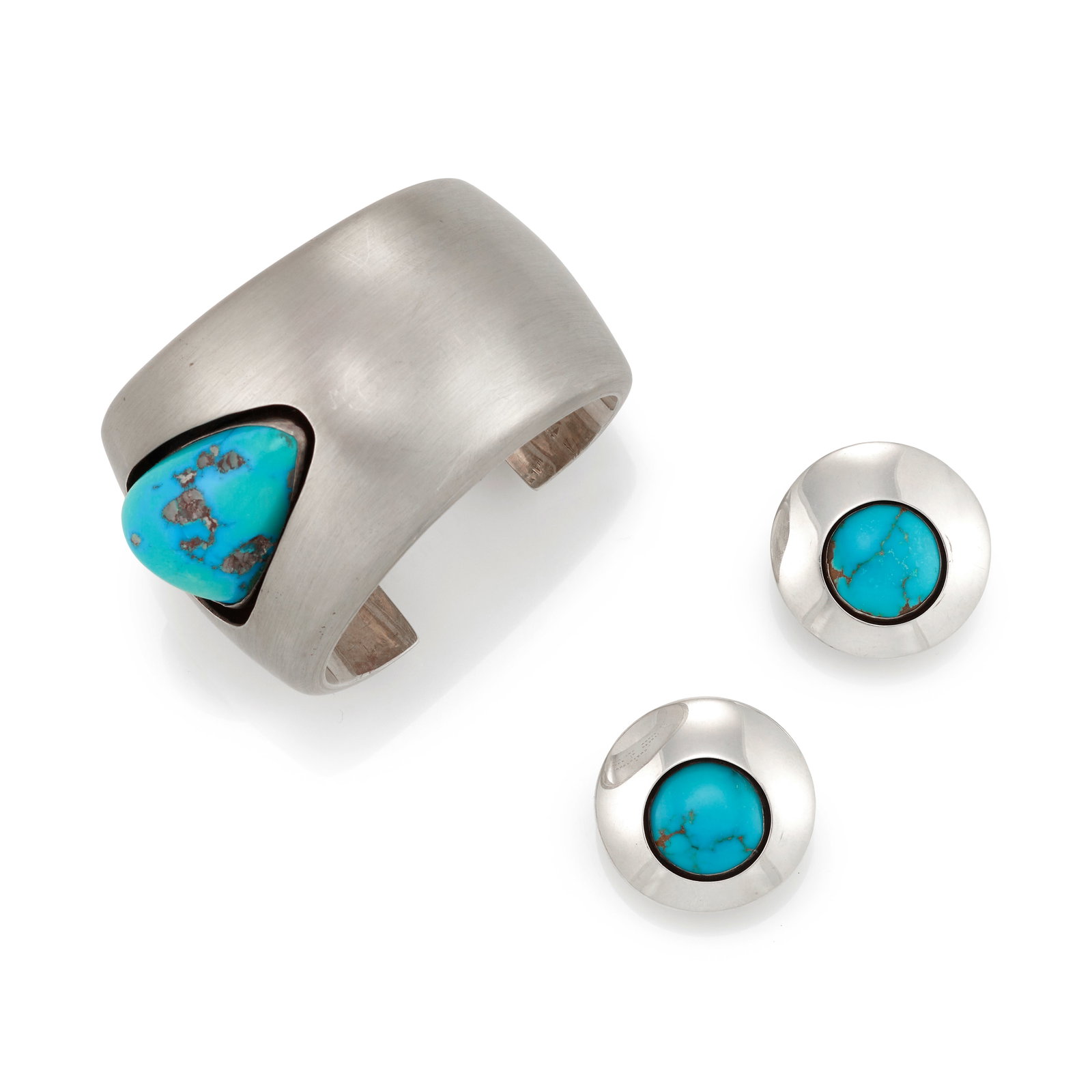 A Kim Rawdin sterling silver cuff bracelet and earrings set with turquoise: Kim Rawdin American, (b. 1950), a sterling silver cuff bracelet with related earrings, bracelet: 'Good Friend,' hollow sterling silver cuff (the exterior brushed, the interior polished) set with a lar