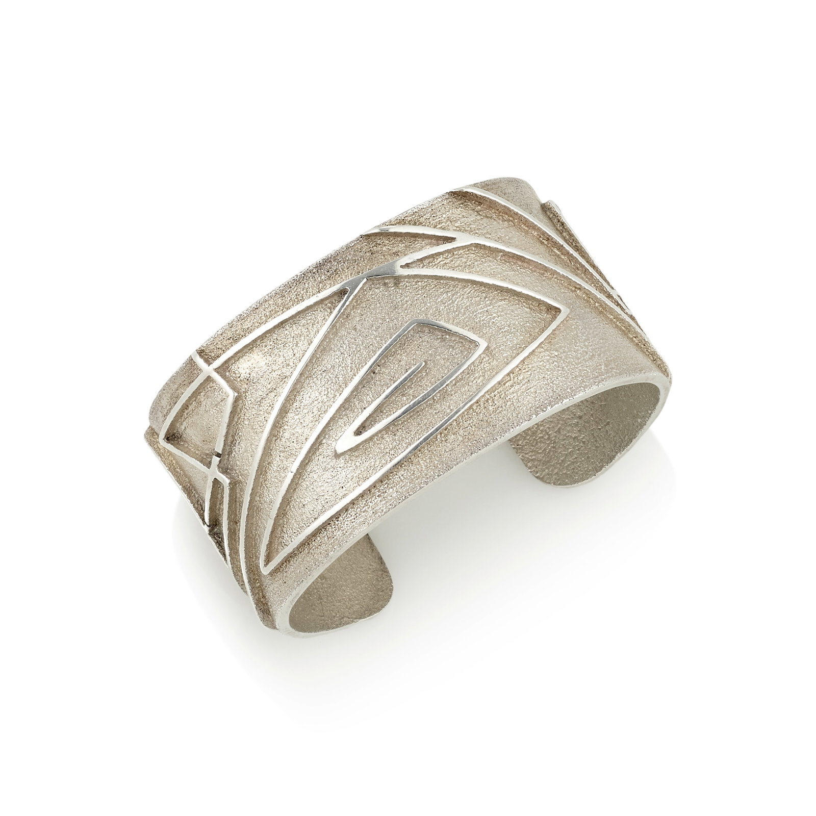 A Jared Chavez sterling silver bracelet: Jared Chavez San Felipe Pueblo/Diné (Navajo)/Hopi, (b. 1976), a tufa cast sterling silver bracelet, with raised abstract linear designs, signed with maker's mark on the interior. interior circumf