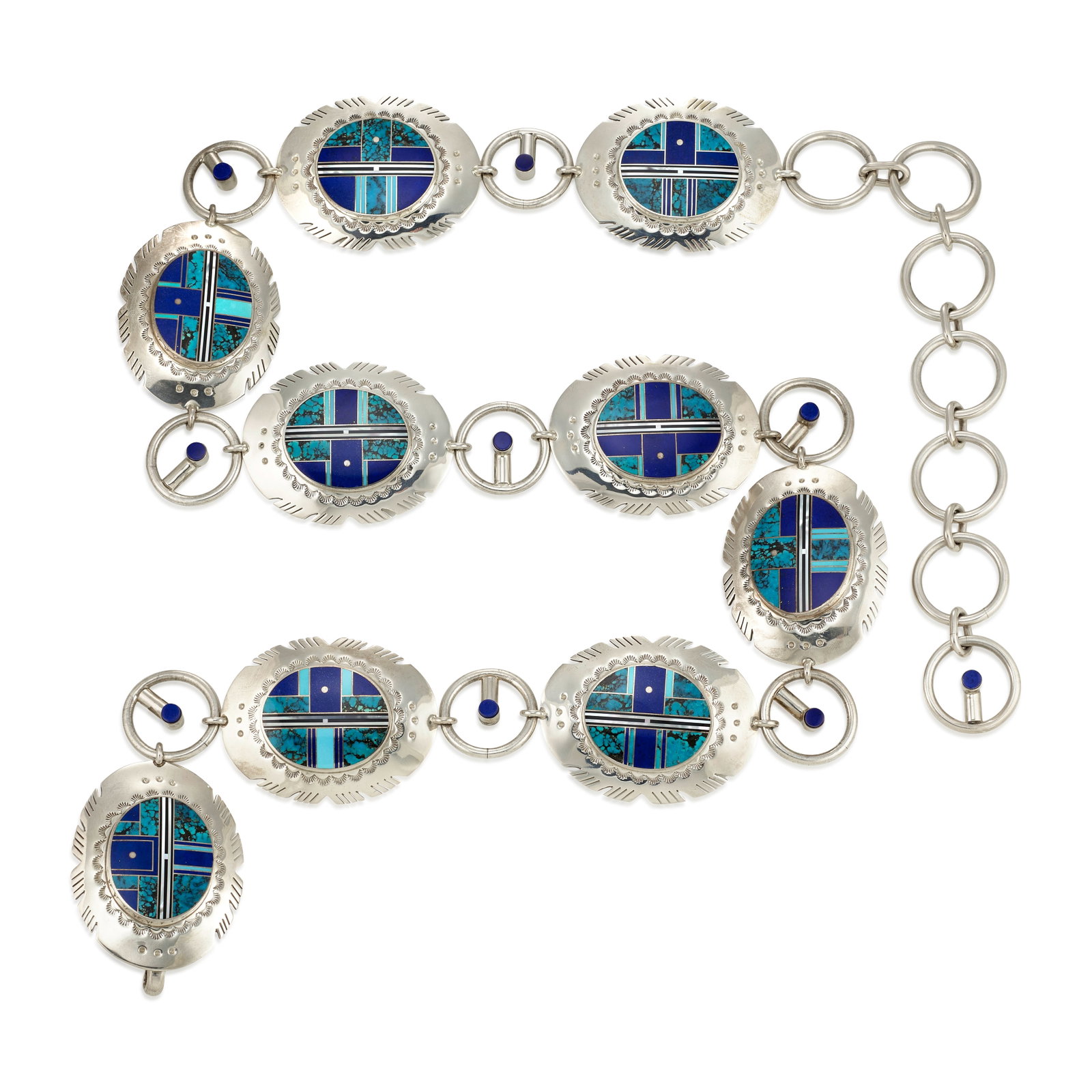 A Benson Manygoats silver and mosaic inlay multi-stone link belt: Benson Manygoats Diné (Navajo), (20th/21st century), a sterling silver concha-style link belt, the buckle and eight conchas inlaid with turquoise, lapis, jet or black jade and other materials in 