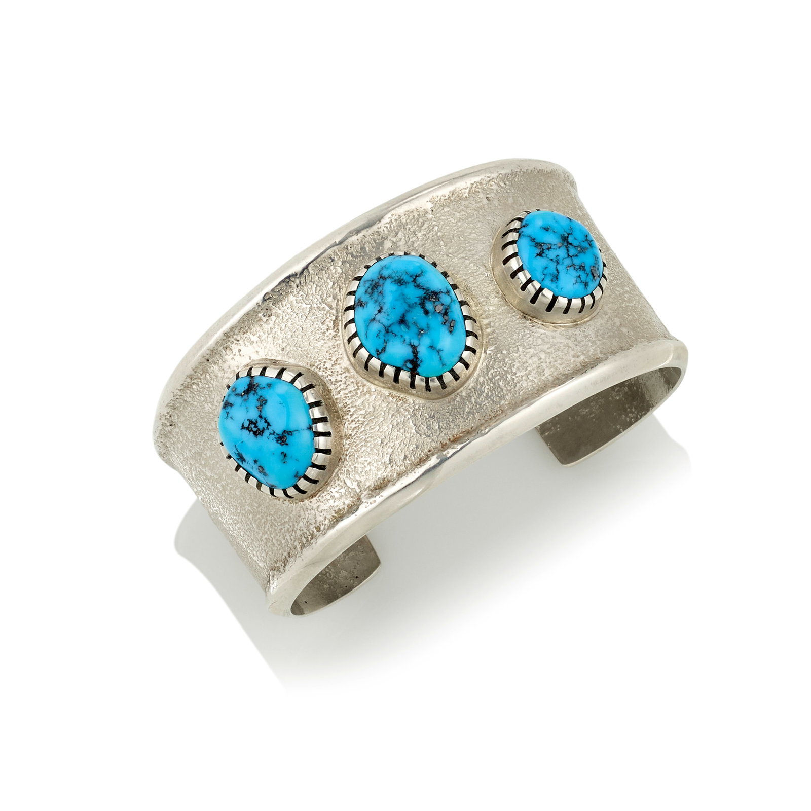 A Verma Nequatewa (Sonwai) silver and turquoise cuff bracelet: Verma Nequatewa (Sonwai) Hopi, (b. 1949), a cast silver cuff bracelet, set with three turquoise cabochons, stamped on the interior with maker's mark: Sonwai. inner circumference (including gap) 6 1/8i