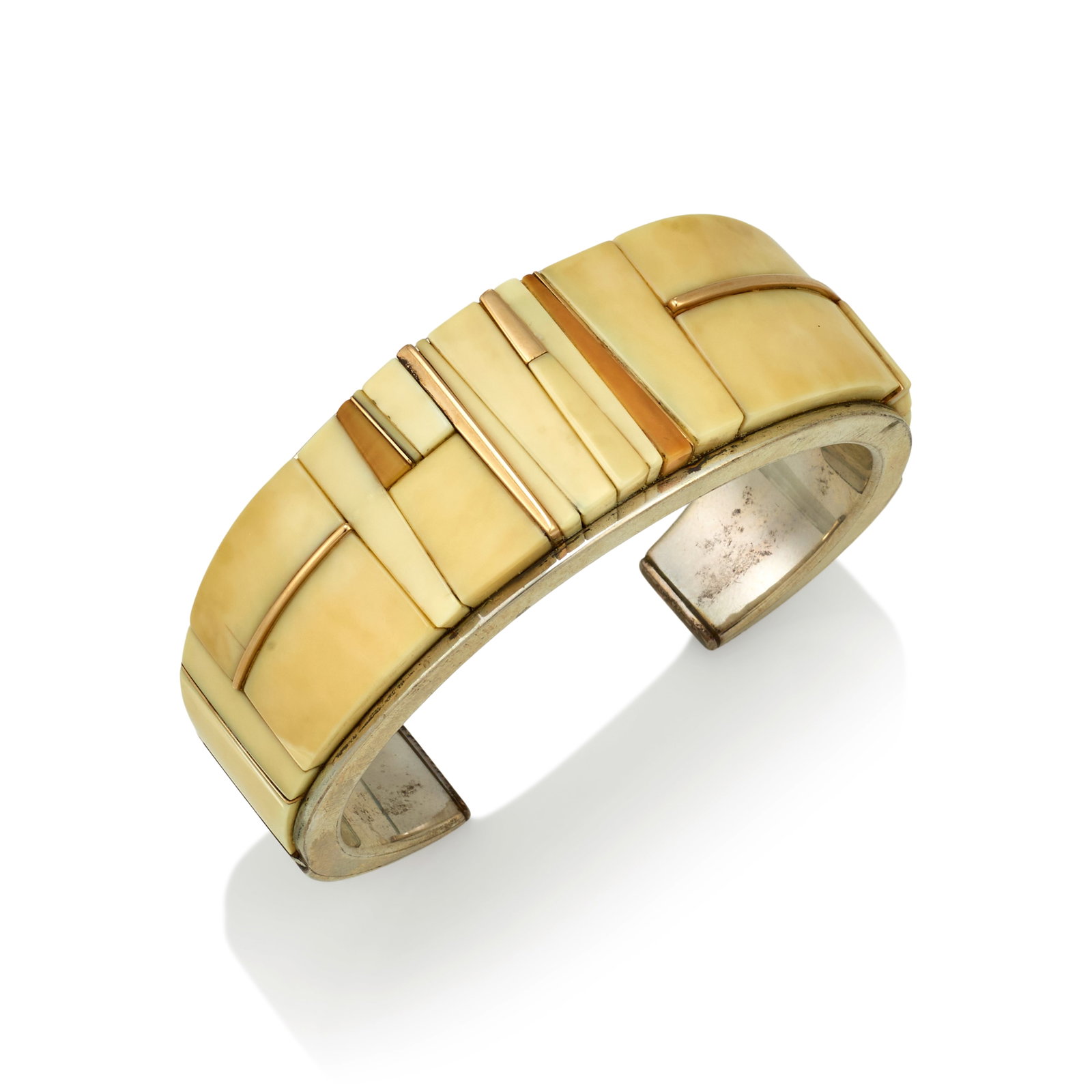 A Luis Mojica silver and mosaic bracelet: Luis Mojica New Mexican, (20th/21st century), a sterling silver cuff bracelet, of tapering form, set with intricate mosaic of fossilized materials framed by gold spacers, stamped on the interior with 