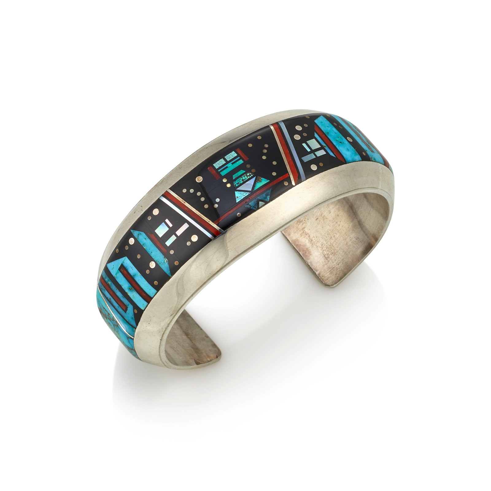 A Jim 'Jimmy' Harrison silver and multi-stone mosaic inlay bracelet: Jim 'Jimmy' Harrison Diné (Navajo), (20th/21st century), a mosaic-inlaid sterling silver cuff bracelet with slightly tapering terminals, inlaid with central Yei figure amongst cosmic motifs, in b