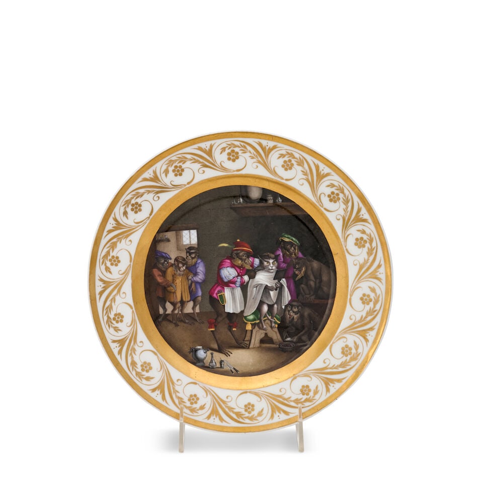 A Berlin Königliche Porzellan-Manufaktur Porcelain Plate with a Singerie Scene of a Cat and...: A Berlin Königliche Porzellan-Manufaktur Porcelain Plate with a Singerie Scene of a Cat and Monkeys in a Barber's Shop German, circa 1830 impressed 25, hand-painted scepter mark in underglaze-blu