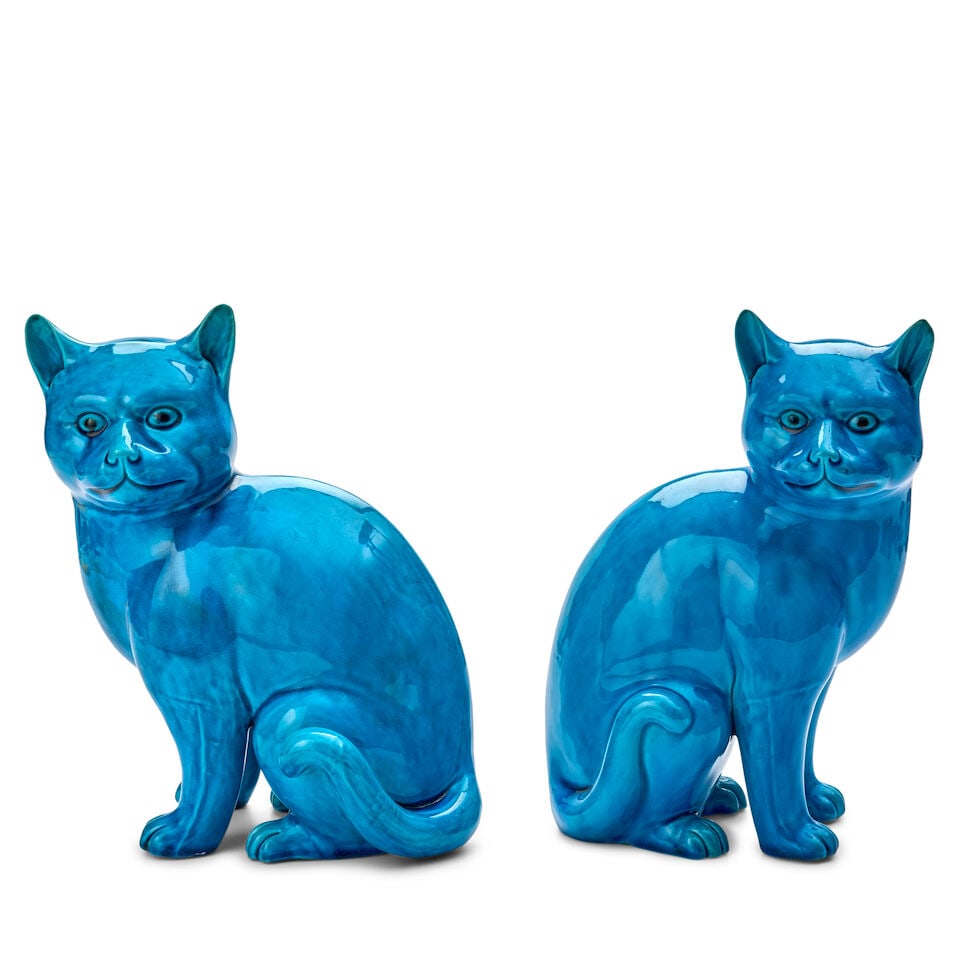 A Pair of Turquoise Porcelain Models of Cats China, 20th century: A Pair of Turquoise Porcelain Models of Cats China, 20th century Both in seated pose but facing in different directions, with alert faces and curled tails. height 10 in. (25.4 cm.); width 6 1/2 in. (1
