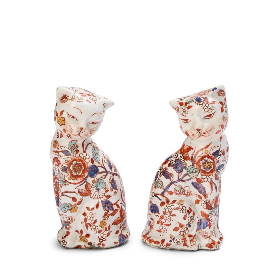 A Pair of Imari Porcelain Models of Cats Japan, Edo period, 18th/19th century: A Pair of Imari Porcelain Models of Cats Japan, Edo period, 18th/19th century Mirroring each other in seated pose, with serene expressions, decorated with flowers and leaves in Imari palette. each hei