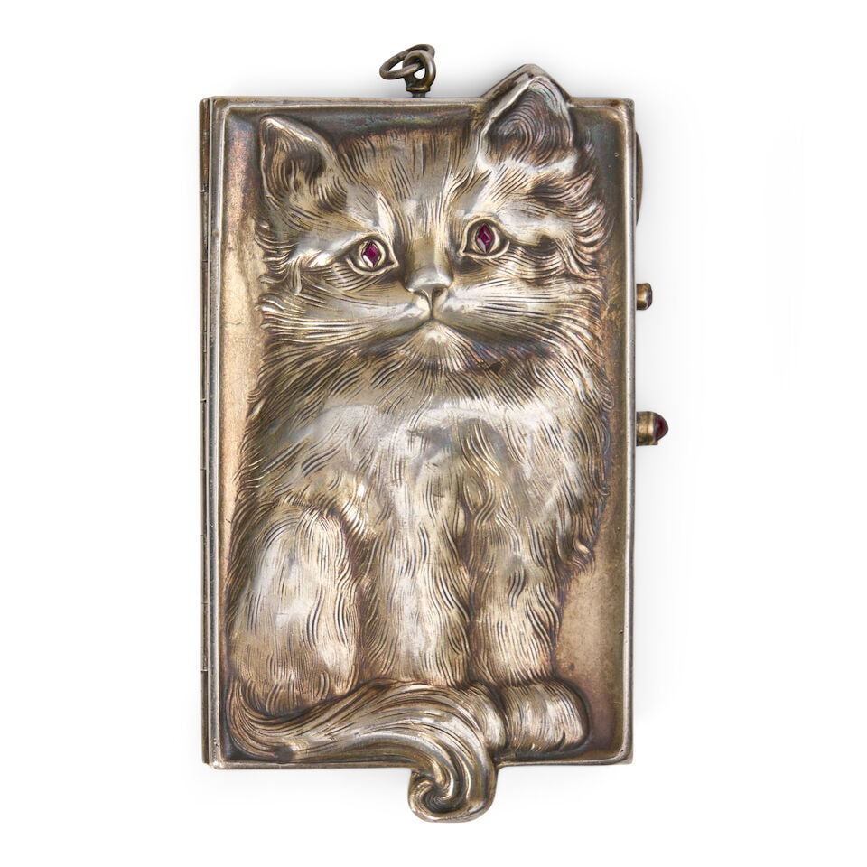 A Silver-gilt Cat Minaudière, After Louis Kuppenheim 20th century, apparently unmarked: A Silver-gilt Cat Minaudière, After Louis Kuppenheim 20th century, apparently unmarked The cover with a seated cat inset with red stone eyes, the rear with cat seen from behind, two cabochon-set 