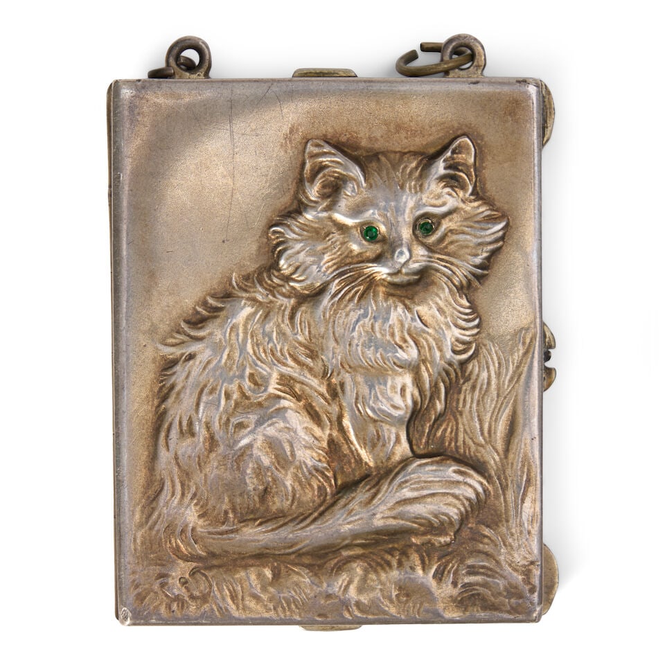 A German Silver-gilt Cat Minaudière late 19th/early 20th century, 800 standard: A German Silver-gilt Cat Minaudière late 19th/early 20th century, 800 standard Of rectangular form, embossed with the front of a cat to both sides, inset green paste eyes, the interior with two s