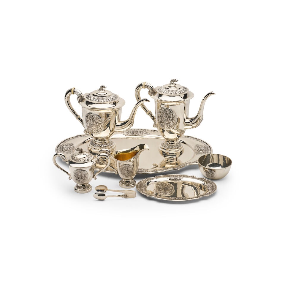 A Thai sterling silver and parcel-gilt tea and coffee service (8): A Thai sterling silver and parcel-gilt tea and coffee service comprising a large tray, small tray, teapot, coffeepot, sugar bowl, creamer, bowl and sugar cube tongs, marked Thailand Sterling 925 purit