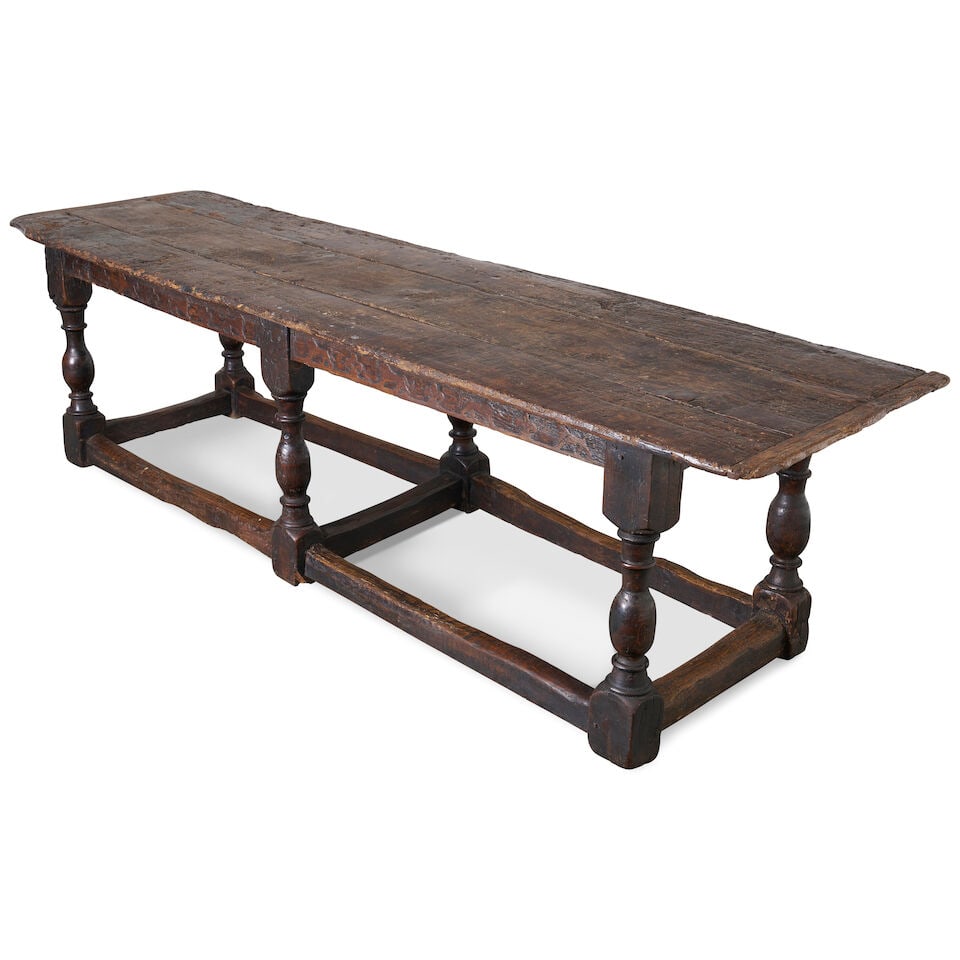 An early oak refectory table, 17th century,: An early oak refectory table, 17th century, with three plank top, above a carved apron showing lions and fleur-de-lis, on six turned baluster legs, connected by boxed stretchers, overall height: