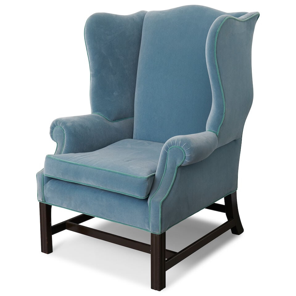 An English Georgian mahogany wing armchair, mid 18th century: An English Georgian mahogany wing armchair, mid 18th century with later upholstery and heavily stained timber legs, with loose seat cushion, raised on moulded square front legs and splayed rear legs,