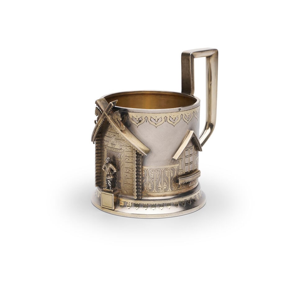 A PARCEL-GILT TEA GLASS HOLDER Unidentified assay master (TH), St Petersburg, 1884: A PARCEL-GILT TEA GLASS HOLDER Unidentified assay master (TH), St Petersburg, 1884 Russian Imperial Mark 1884, 84 zolotniks, 875/1000 purity, of circular form, applied with gilt windows and the
