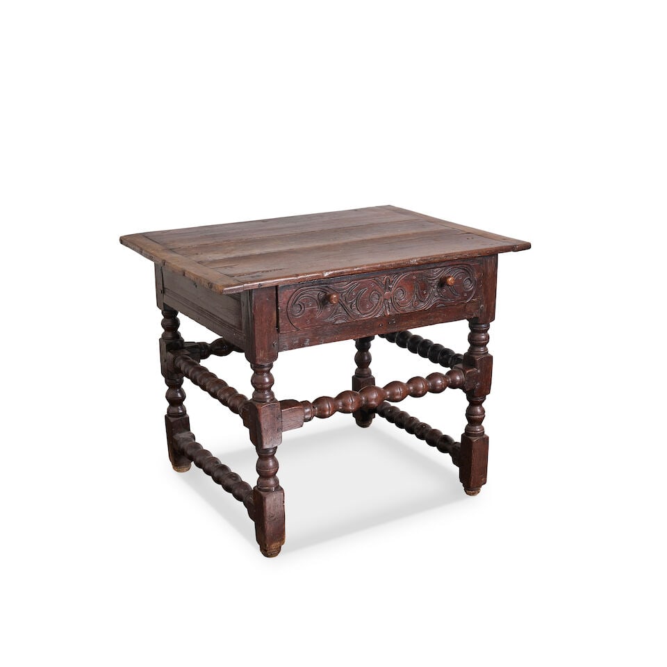 An oak side table, late 17th/ early 18th century,: An oak side table, late 17th/ early 18th century, with three plank top above single frieze drawer with incised carving to the drawer front, raised on bobbin turned legs, with matching peripheral stret