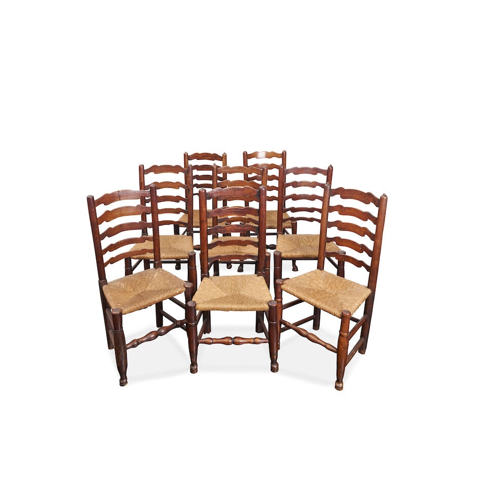 A matched set of ten ladder-back dining chairs: A matched set of ten ladder-back dining chairs consisting of two carvers and eight chairs, all with rush seats upon cabriole legs, in mixed forestry woods, predominantly ash and elm, all with loose