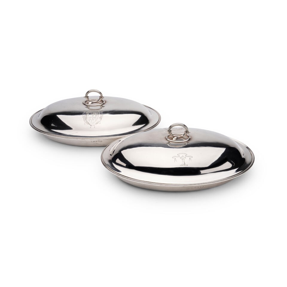 A pair of George III English silver lidded serving dishes, Marks of Daniel Smith & Robert Sharp,...: A pair of George III English silver lidded serving dishes, Marks of Daniel Smith & Robert Sharp, London, 1786 each oval serving dish with domed cover surmounted by a reeded leaf-capped loop handle,