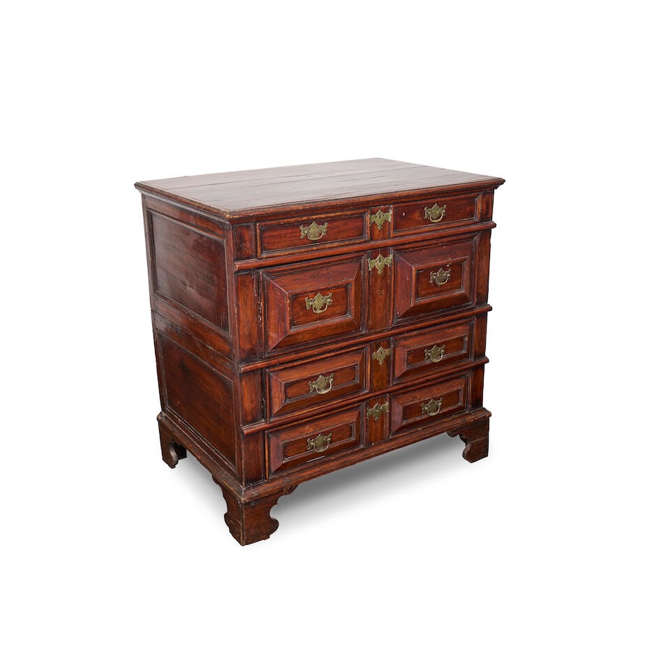 An English chest of drawers,: An English chest of drawers, in the Jacobean style with geometric decoration to the drawer fronts, with two-part sectional construction, overall height: 97.0cm, width: 97.0cm, depth: 63.0cm For