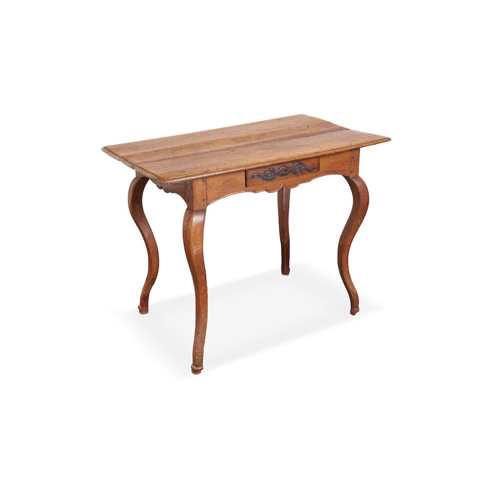 A French Louis XV side table,18th century,: A French Louis XV side table, 18th century, with rectangular top above a single frieze drawer, in shaped apron raised on cabriole legs, in mixed timbers including ash, elm and oak, height: 67.0cm, wid