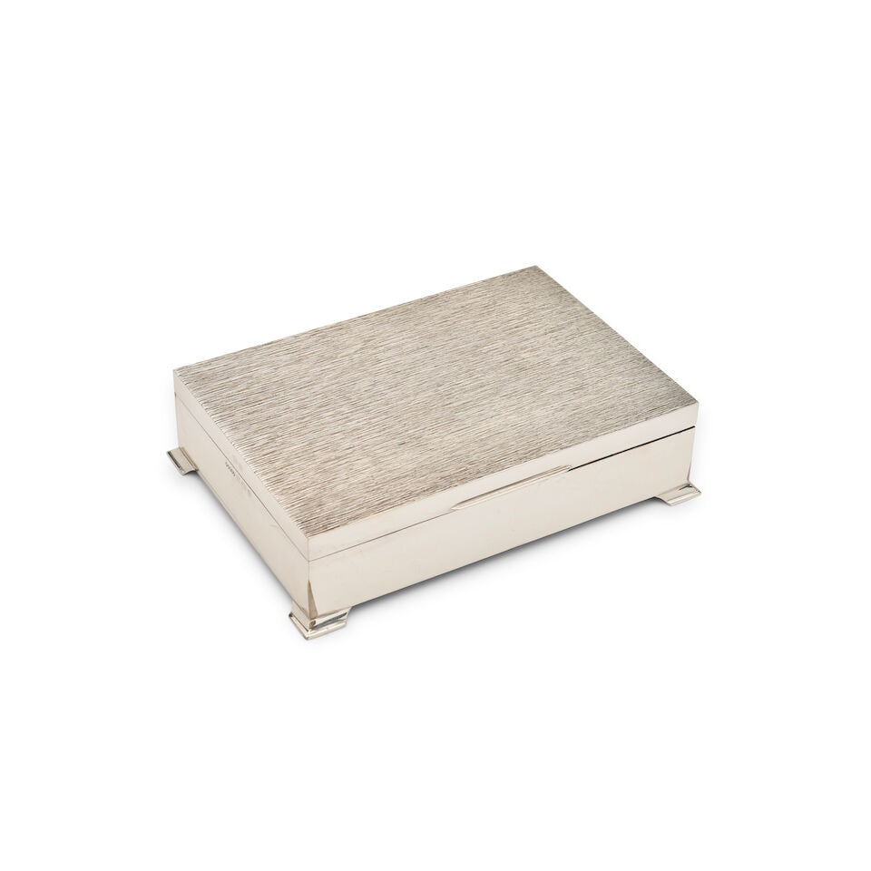 An English silver cigar box: An English silver cigar box with cedar lining, marks of Harman Brothers, Birmingham, 1951, 16.5 width, 11.8cm depth, 4.5cm high, weight total 658 grams For further information on this lot please