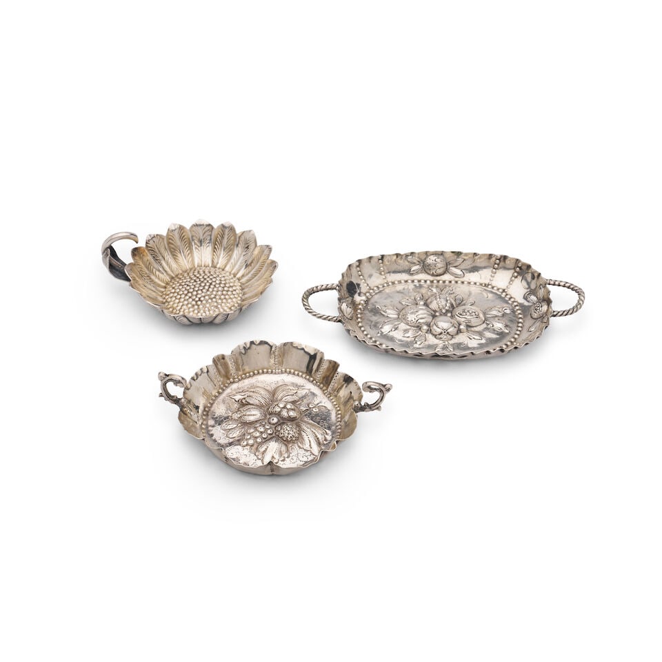 Three miniature German 800 standard silver dishes, the two-handled dishes in the manner of Lazar...: Three miniature German 800 standard silver dishes, the two-handled dishes in the manner of Lazarus Posen, Germany, circa 1890, with decorative central repoussé bases depicting fruit and flowers,